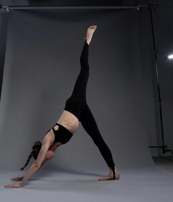 Person practicing balance yoga in a bright minimal studio
